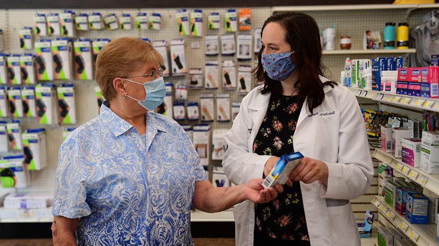 Dr. Katie Perry serving a patient at Cedar Care Village Pharmacy