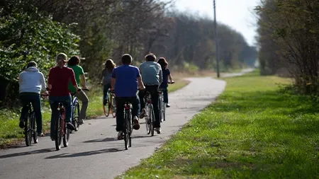 Students biking on path