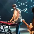 Studentsplayingkeyboardguitaranddrumsonstageinchapel