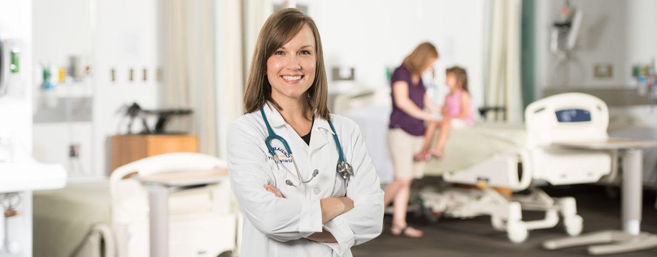 Female Nurse Practitioner stands in hospital