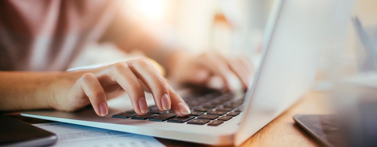 Male typing on a laptop