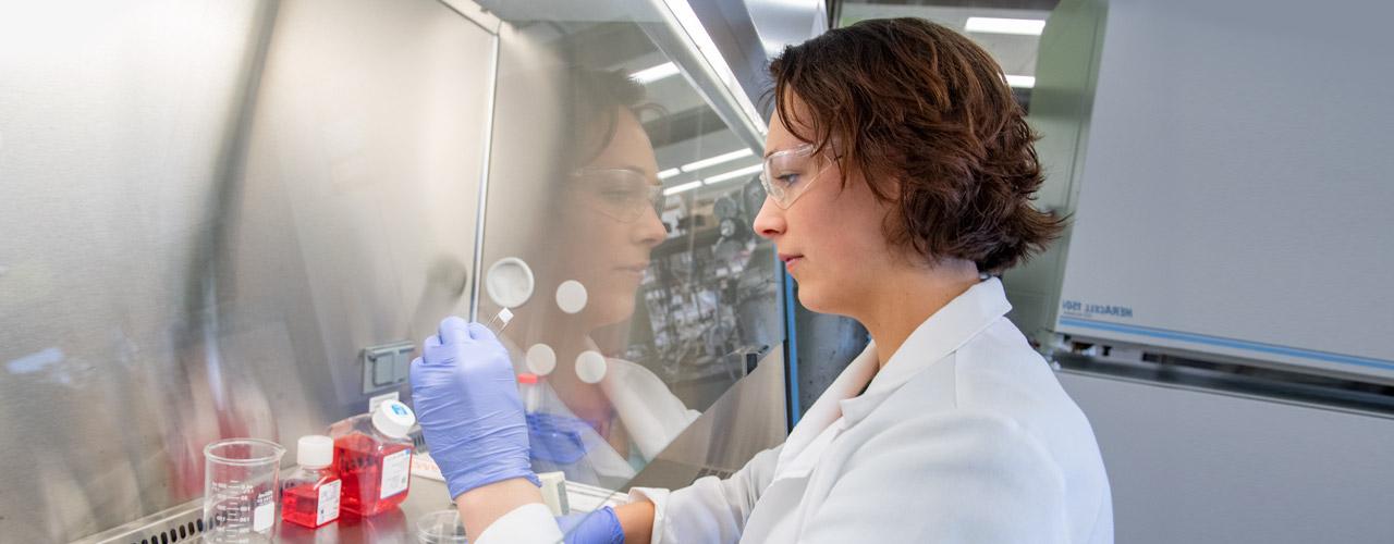 Woman in lab gear.