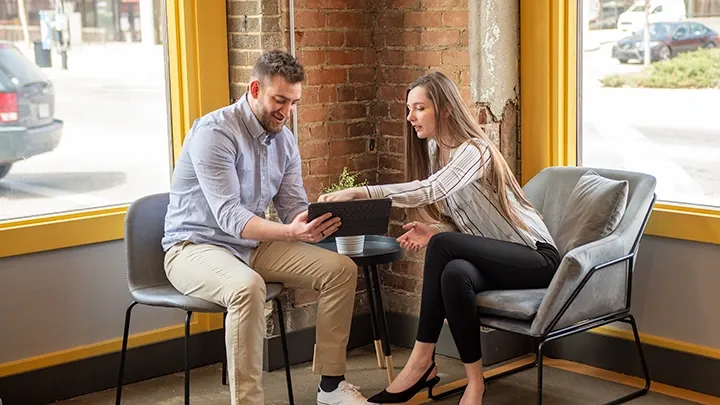 2 people looking at a tablet.