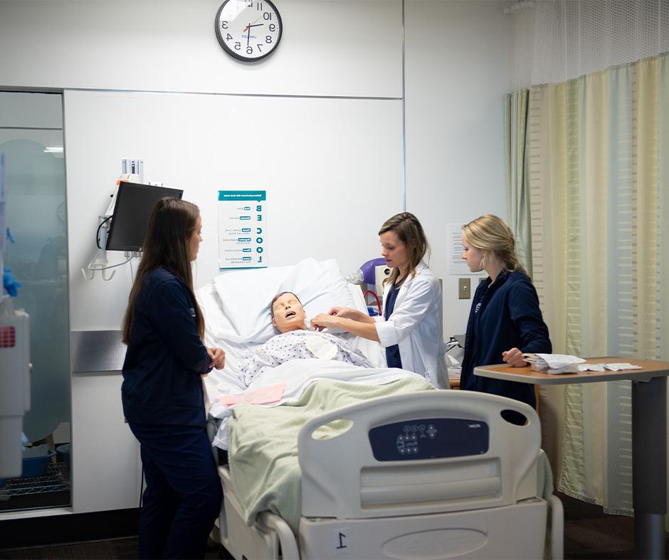 Nursing students working with simulated patient.