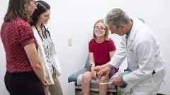 PA  professor examines a girl while students look on.